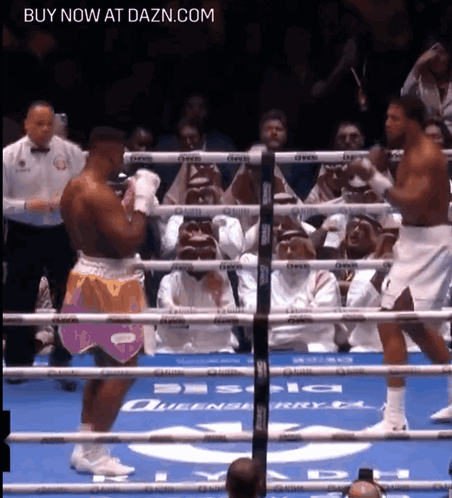 Two Boxers Are Fighting In A Boxing Ring With The Words Buy Now At Dazn.com Above Them GIF