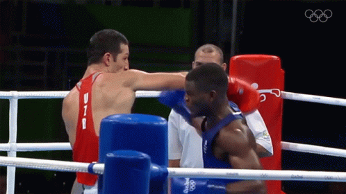 Two Boxers Are Fighting In A Ring And One Has The Letter B On His Shirt GIF