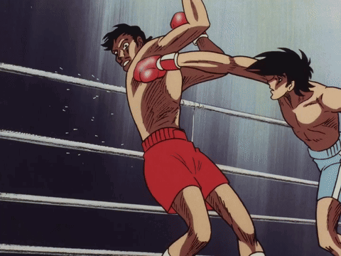 Two Boxers Are Fighting In A Ring And One Is Wearing Red Gloves GIF
