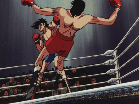 Two Boxers Are Fighting In A Ring With A Crowd In The Background GIF