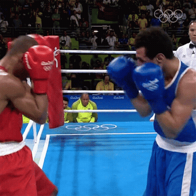 Two Boxers Are Fighting In A Ring With A Sign That Says Rio2016 GIF