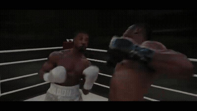 Two Boxers Are Fighting In A Ring With A Sign That Says World Heavyweight Champions On It GIF