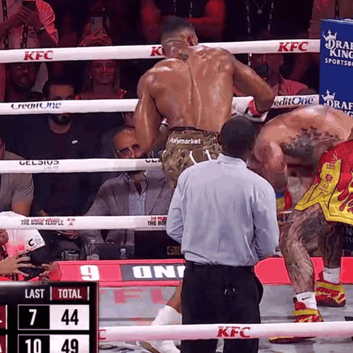 Two Boxers Are In A Ring With A Scoreboard That Says Last Total 7 44 10 49 GIF