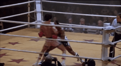Two Boxers Fighting In Boxing Ring With Referee GIF