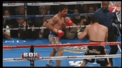 Two Boxers Fighting In Ring With Box On Ropes GIF