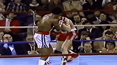 Two Boxers Fighting In Ring With Letter T GIF