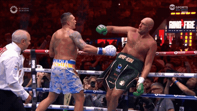 Two Boxers Fighting, One Wearing 'Npsy-King' Shorts GIF