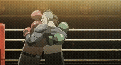 Two Boxers Hugging In A Boxing Ring With One Wearing A Glove That Says ' Pa ' On It GIF