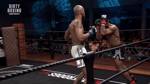 Two Boxers In A Boxing Ring With Dirty Boxing Championship Written On The Ropes GIF
