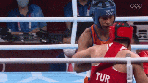 Two Boxers In A Ring One Of Whom Is Wearing A Tur Jersey GIF