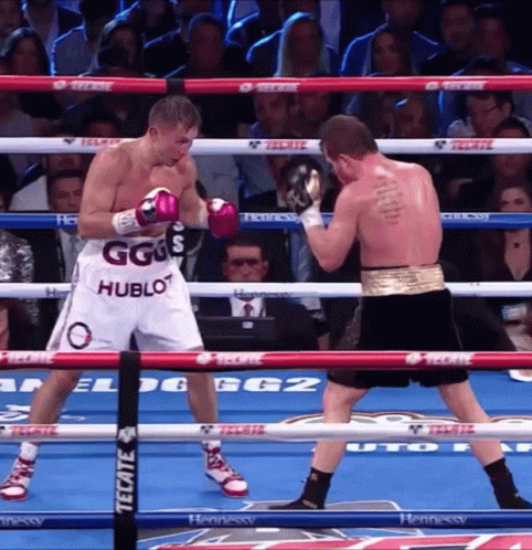 Two Boxers In A Ring With One Wearing Shorts That Say Ggs Hublot GIF