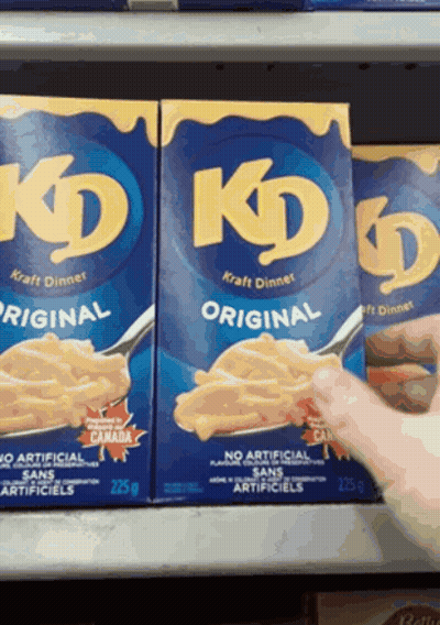 Two Boxes Of Kd Original Kraft Dinner Are On A Shelf GIF