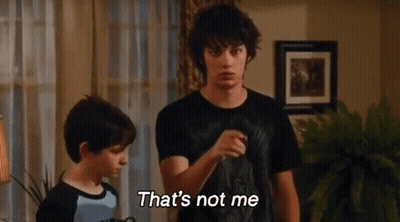 Two Boys Are Standing Next To Each Other In A Living Room And One Of Them Is Saying That 'S Not Me . GIF