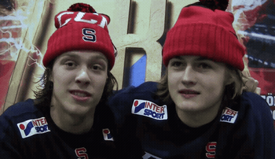 Two Boys In Red Beanies With Letters S And U GIF
