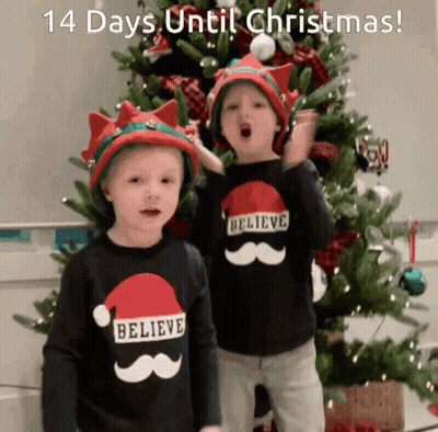 Two Boys In Santa Hats Saying Believe GIF