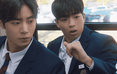 Two Boys In Suits And Ties Are Sitting Next To Each Other With One Wearing A Name Tag That Says ' A ' GIF