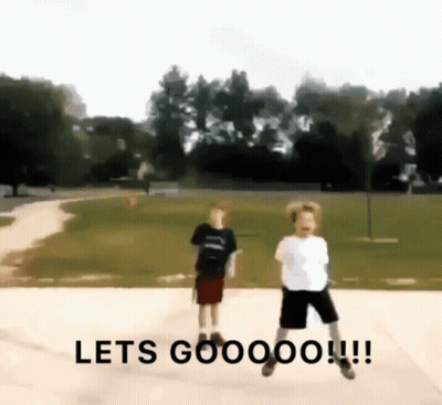 Two Boys Jumping In Park Saying Let's Goooo GIF
