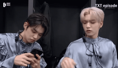 Two Boys Looking At Phones Saying Xt Episode GIF