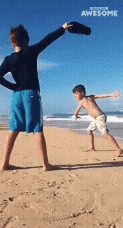 Two Boys Playing On Beach With Awesome GIF