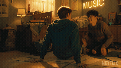 Two Boys Sit On The Floor In A Bedroom With A Music Sign Above Them GIF