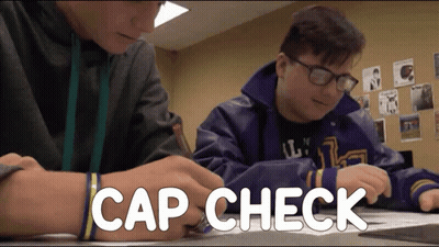 Two Boys Sitting At Desk With Cap Check GIF