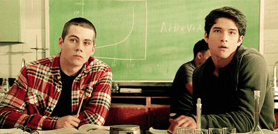 Two Boys Sitting In Front Of Chalkboard With Formula GIF