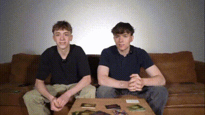 Two Boys Sitting On Couch With Table GIF