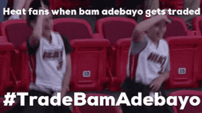 Two Boys Sitting With Arms Up In Stadium GIF