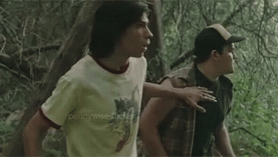 Two Boys Standing In A Forest GIF