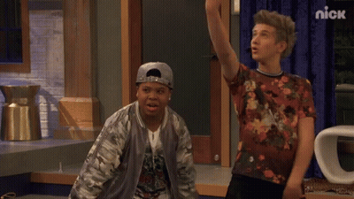 Two Boys Standing Next To Nick Sign GIF