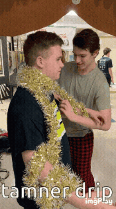 Two Boys Wearing Tinsel With Tamner Drip GIF