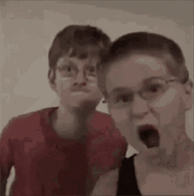 Two Boys With Glasses Making Funny Faces