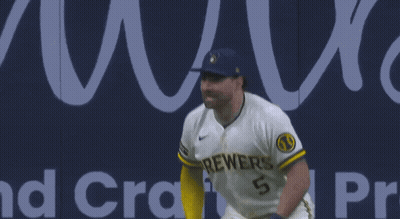 Two Brewers Baseball Players Standing In Front Of Banner GIF