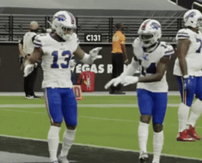 Two Buffalo Bills Players Standing On Field GIF