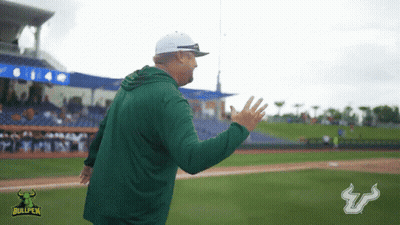 Two Bullpen Football Players Shake Hands In Front Of Raymond James Stadium Billboard GIF