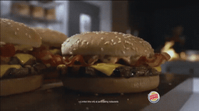 Two Burger King Hamburgers Are Sitting On A Counter GIF
