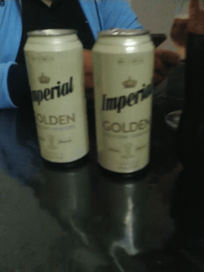 Two Cans Of Imperial Golden Sit On A Table GIF