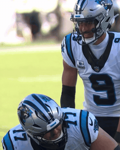 Two Carolina Panthers Players in White and Blue Uniforms