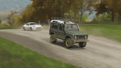 Two Cars Are Driving Down A Dirt Road And One Has A Roof Rack GIF
