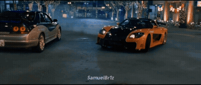 Two Cars Driving Down Street GIF