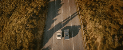 Two Cars Driving With Arrow Pointing Right GIF