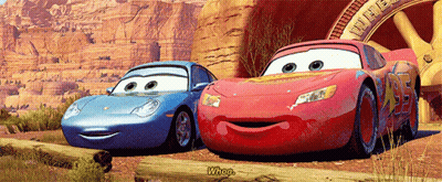 Two Cars From The Movie Cars Are Standing Next To Each Other GIF
