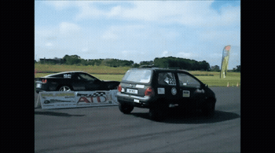 Two Cars Racing On Track With ATD Sign GIF