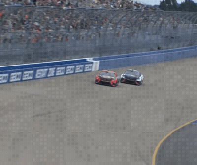 Two Cars Racing On Track With Coca Cola Sign GIF