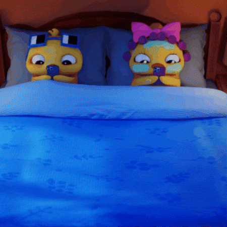 Two Cartoon Characters Are Laying On A Bed With A Blue Comforter GIF