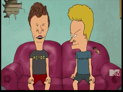 Two Cartoon Characters Are Sitting On A Couch One Is Wearing A Ac Dc Shirt And The Other Is Wearing A Metallica Shirt GIF