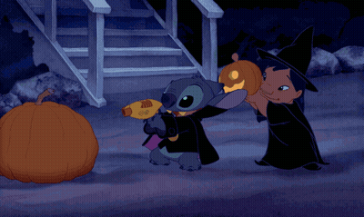 Two Cartoon Characters Beside Glowing Pumpkin GIF