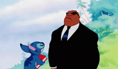 Two Cartoon Characters In Suits Holding Book GIF