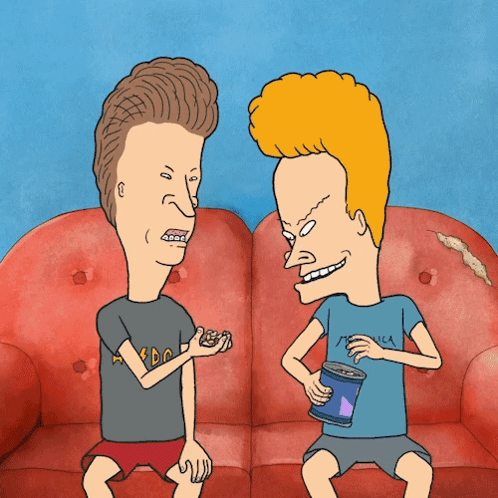 Two Cartoon Characters On Couch One Wearing Metallica Shirt GIF