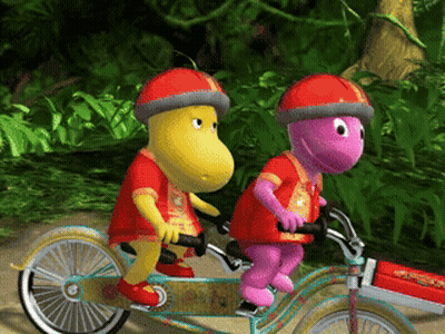 Two Cartoon Characters Riding Tandem Bicycle GIF